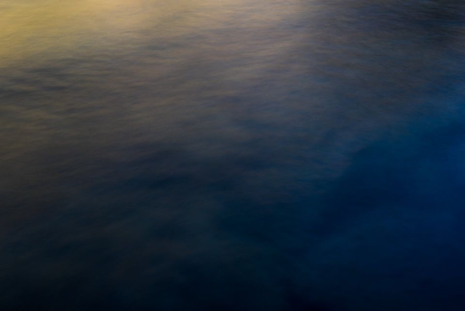 Abstract Motion, Middle Fork Salmon. Sunset light off the hillside and river surface, slowed by a long exposure, shows the subtle colors between sun and shade.