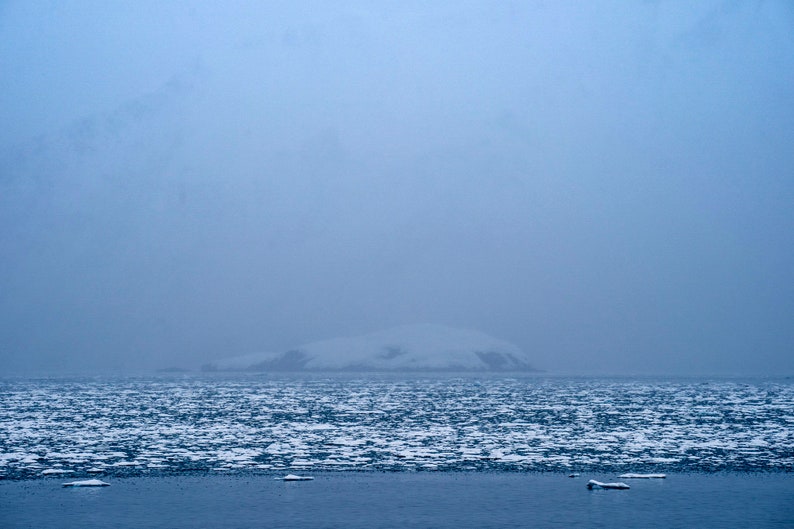 Glacial Ice and Obscured Peaks, Kenai Fjords, Alaska. Glacial ice floats in front of Squab Island in Aialik Bay while a spring storm hides the high peaks.