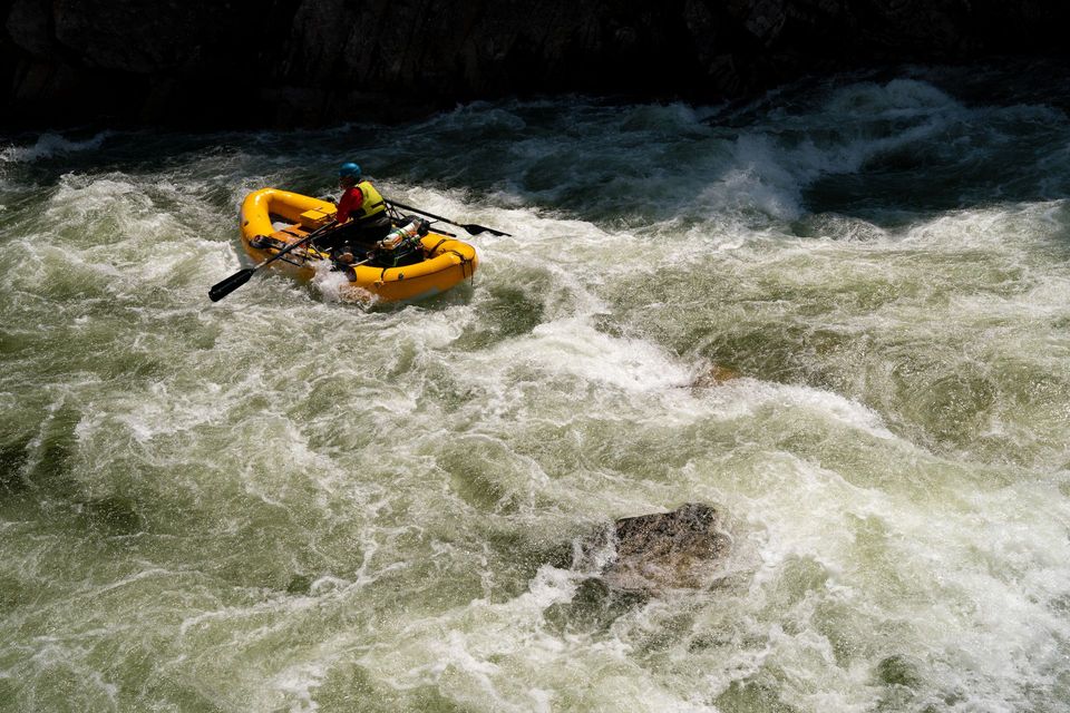 Rafting the South Fork. Matt Leidecker takes his AIRE raft through the final moves of a South Fork rapid.