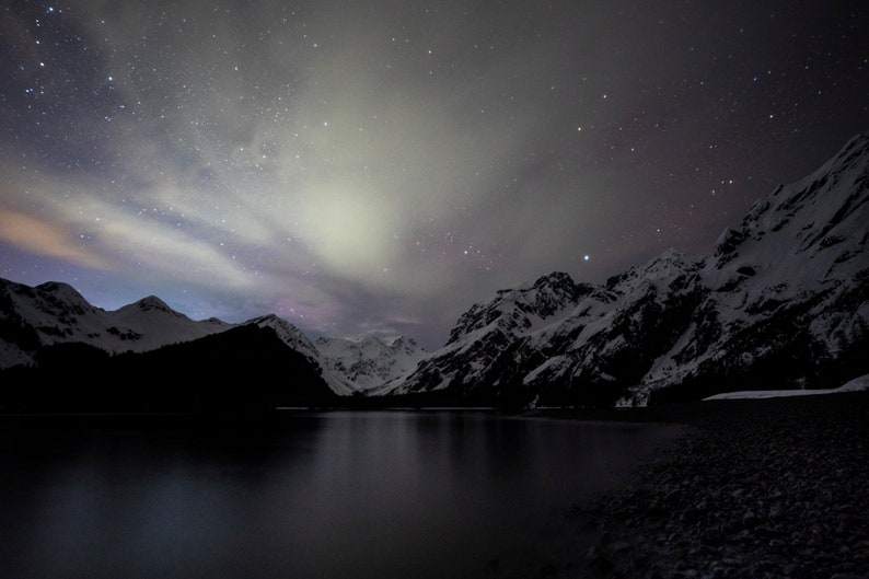 Starry Night in Thumb Cove, Alaska. Stars and lit clouds above Thumb Cove in Resurrection Bay near Seward.