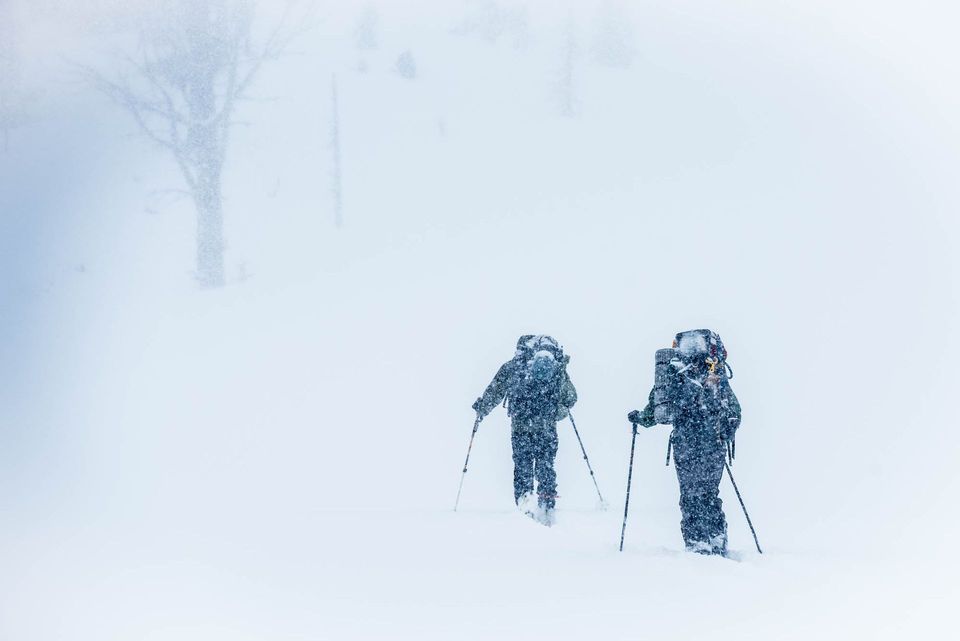 Whiteout. After breaking camp, Matt and Judd skin through a whiteout on the way back to civilization.