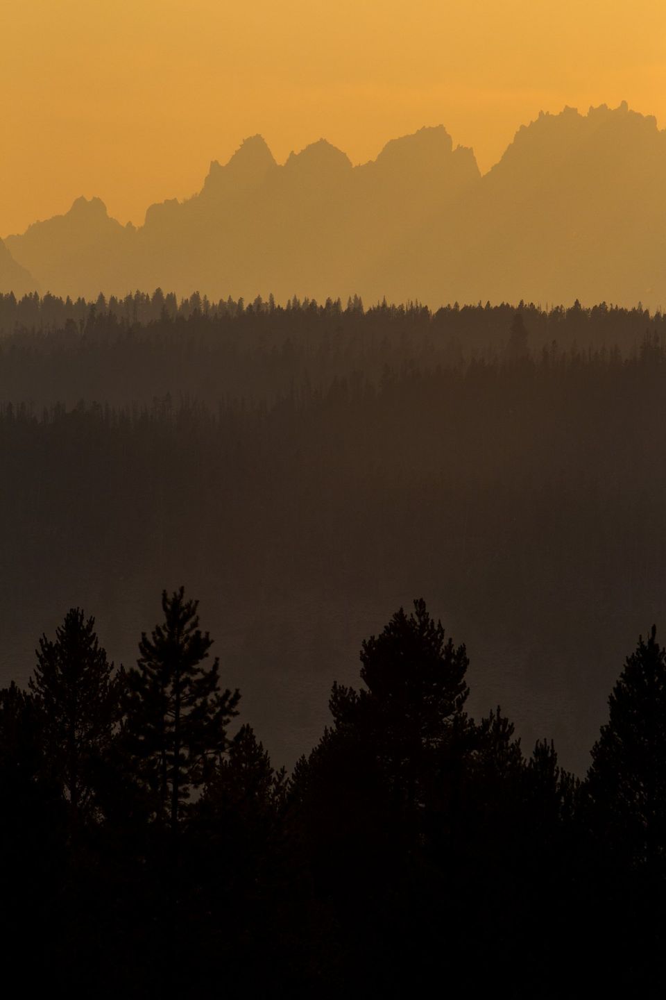 Wildfire Sunset, Sawtooth Mountains, Idaho. Particulate matter from wildfires refracts sunlight in beautiful ways at sunset.